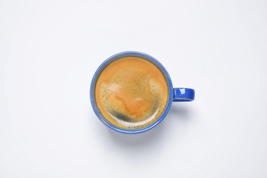 Photo of Coffee in cup on white background, top view. Color of the year 2020 (Classic blue)