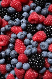 Photo of Assortment of fresh ripe berries as background, top view