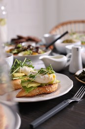 Delicious sandwiches with eggs and avocado served on buffet table for brunch