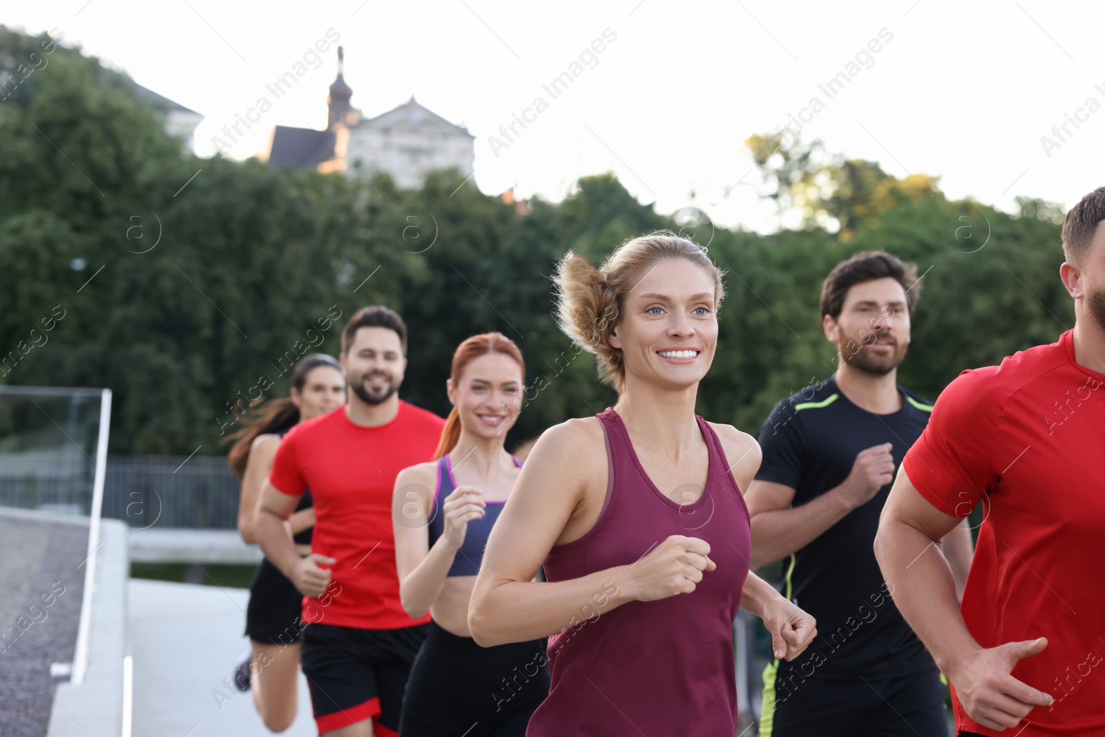 Photo of Group of people running outdoors. Active lifestyle