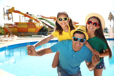 Happy family at water park. Summer vacation