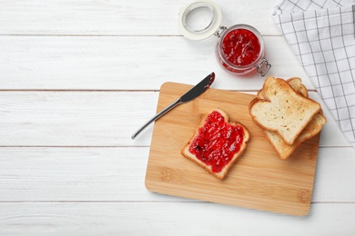 Photo of Toasts with jam on wooden background, top view