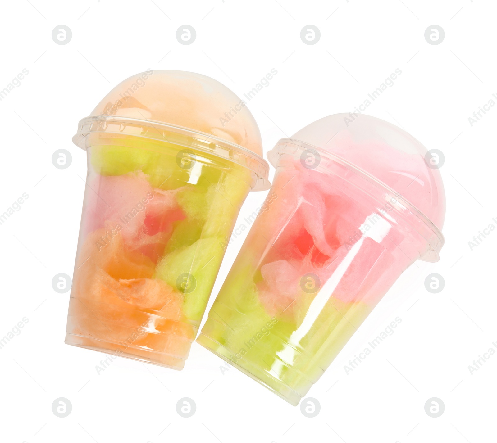 Photo of Plastic cups with tasty cotton candies on white background, top view