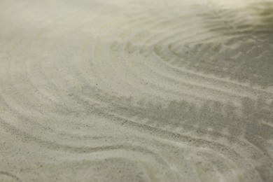 Photo of Beautiful lines and shadows of leaves on sand, closeup. Zen garden