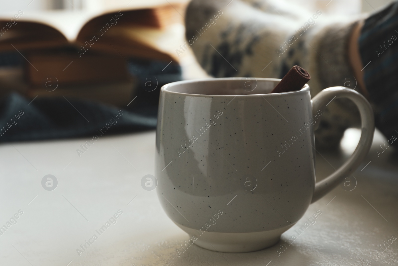 Photo of Cup of delicious mulled wine indoors. Winter drink