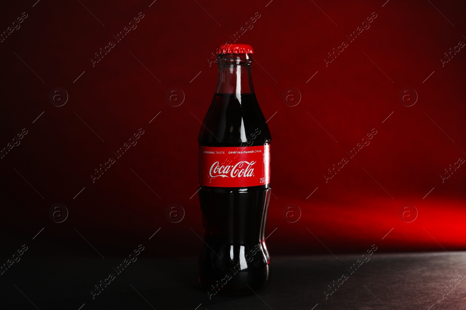 Photo of MYKOLAIV, UKRAINE - NOVEMBER 14, 2018: Bottle of Coca-Cola on color background