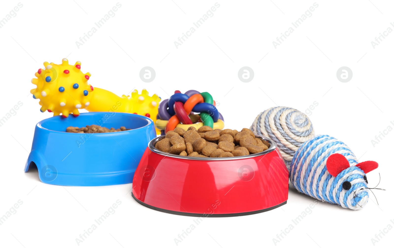 Photo of Feeding bowls and toys for pet on white background