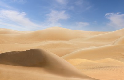 Image of Picturesque view of sandy desert and blue sky on hot sunny day 