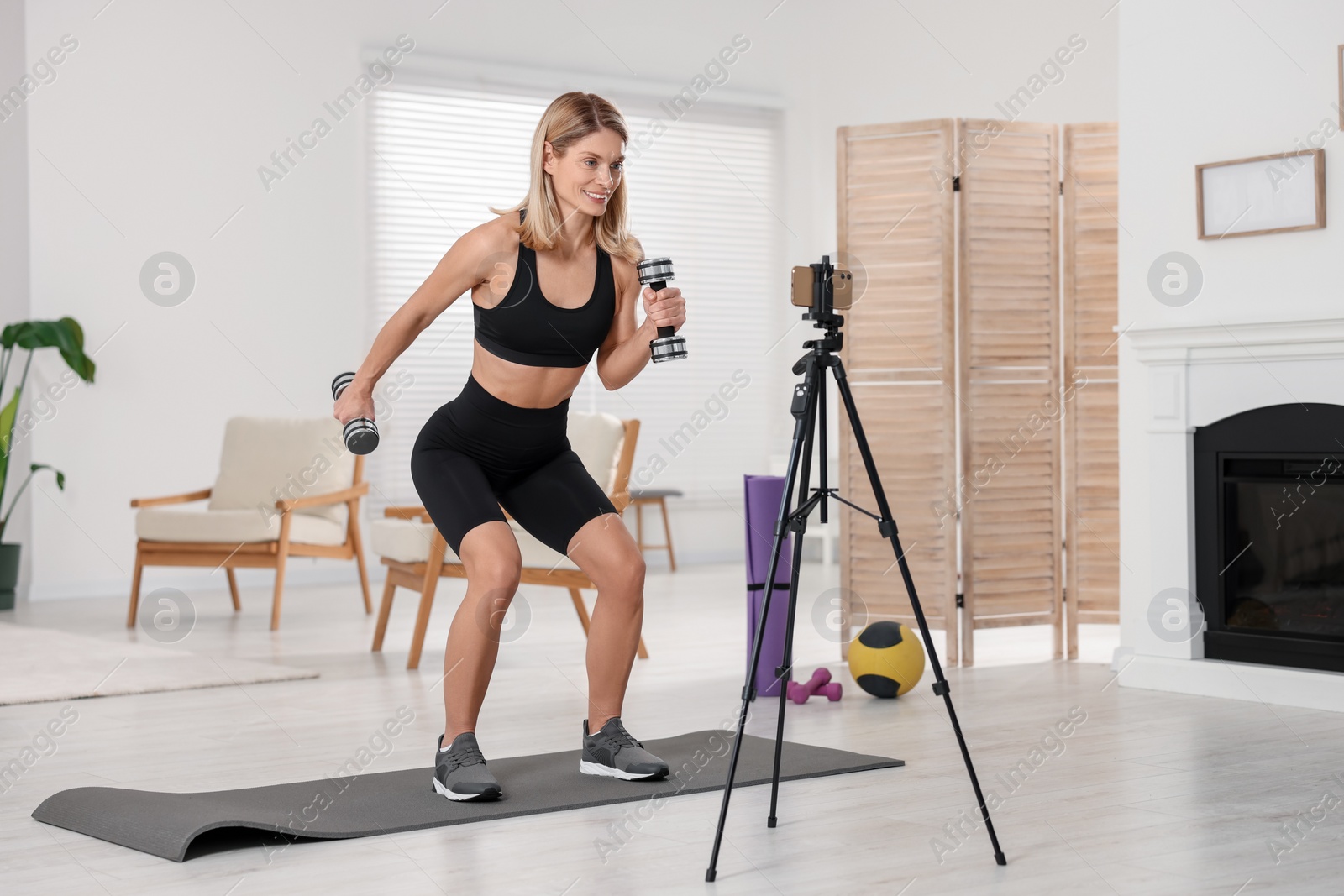 Photo of Fitness trainer recording online classes at home