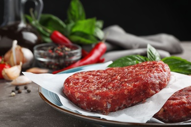 Photo of Raw meat cutlets for burger on table, closeup