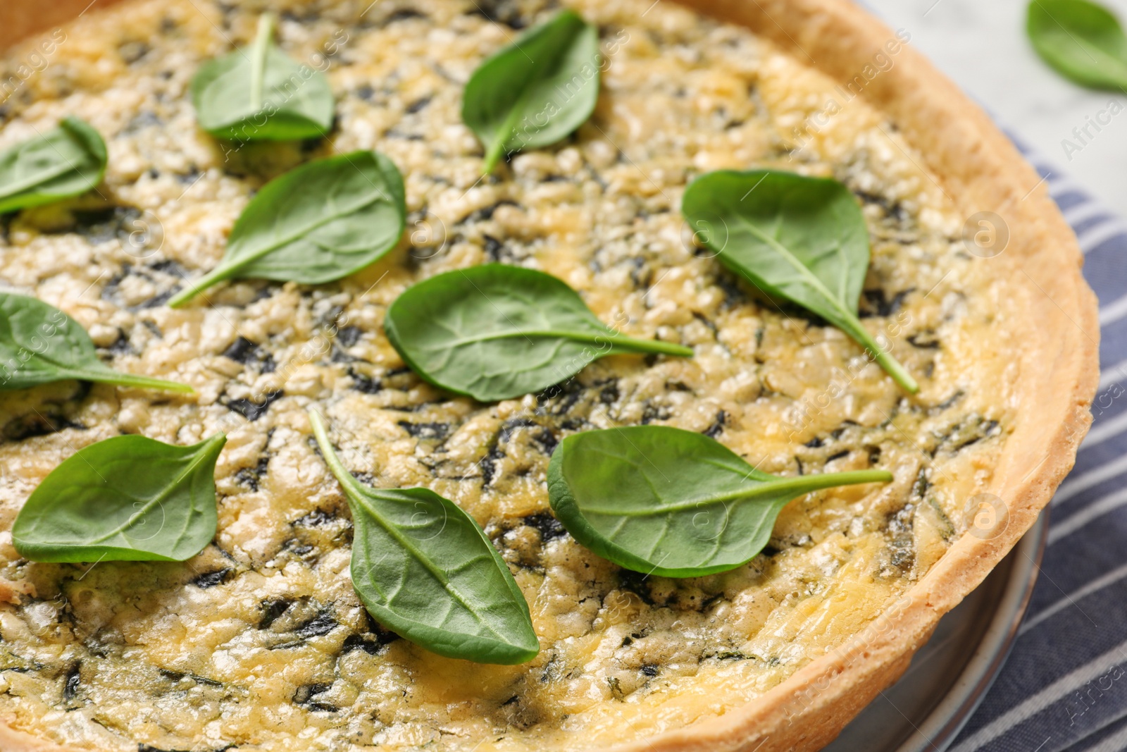 Photo of Delicious homemade spinach pie on table, closeup