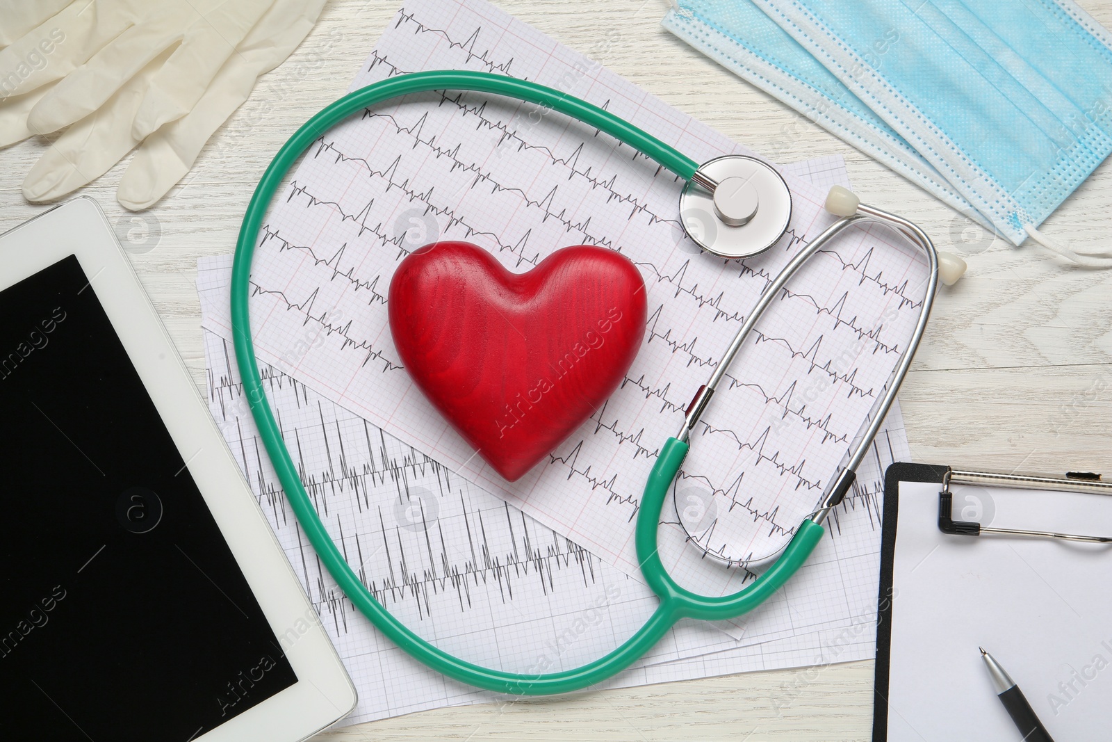 Photo of Flat lay composition with stethoscope and red heart on white wooden table. Cardiology concept