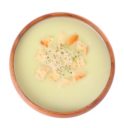 Photo of Bowl of tasty leek soup with croutons isolated on white, top view