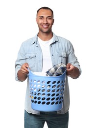 Photo of Happy man with basket full of laundry on white background