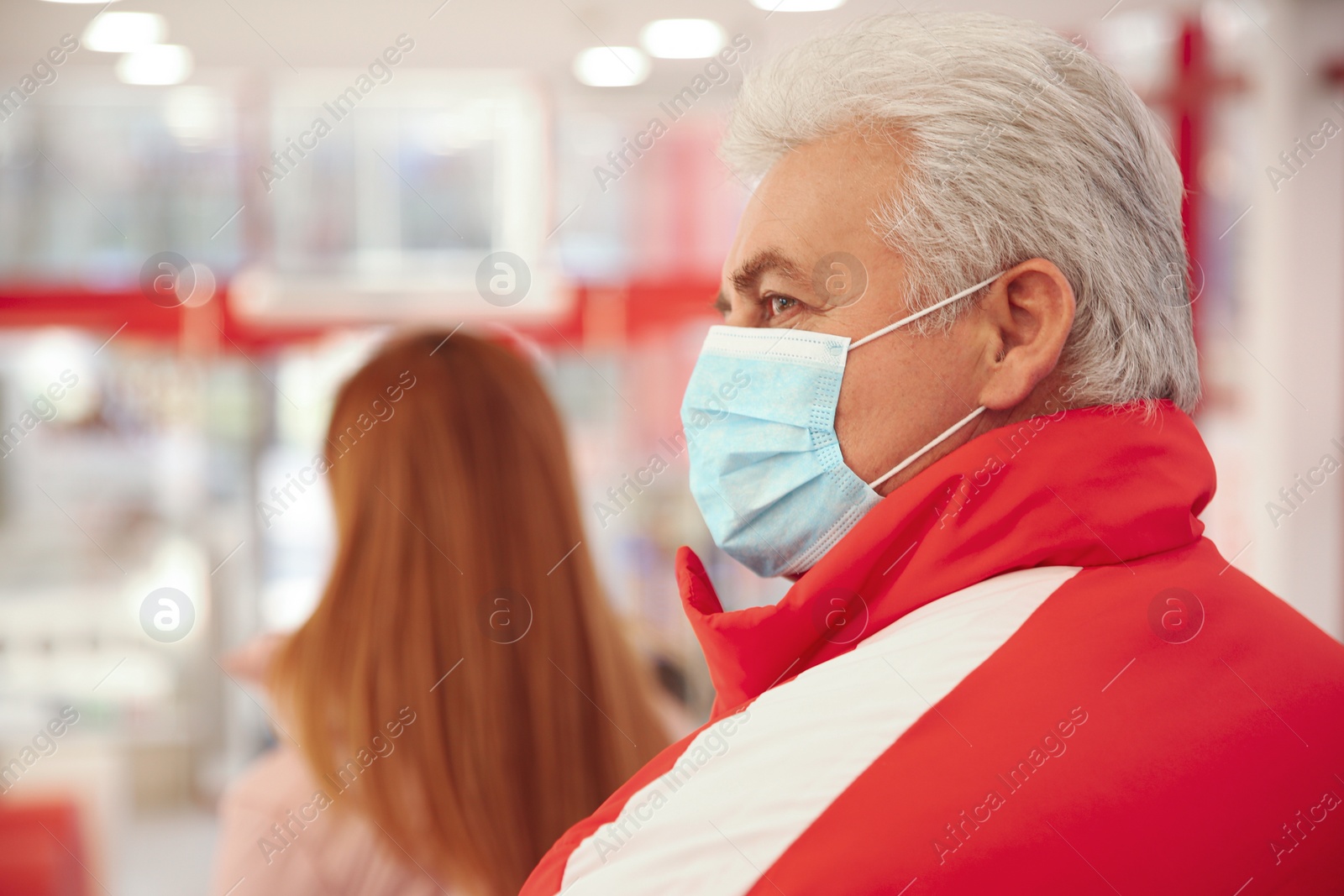 Photo of Senior man with medical mask indoors. Virus protection