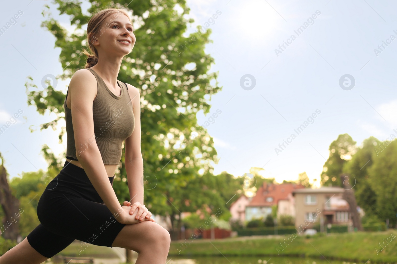 Photo of Teenage girl doing morning exercise in park, space for text