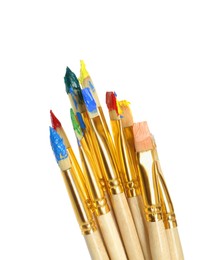 Photo of Brushes with bright paints on white background