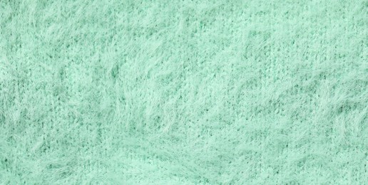 Photo of Texture of soft turquoise fabric as background, top view