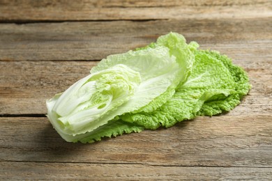 Photo of Cut fresh Chinese cabbage on wooden table