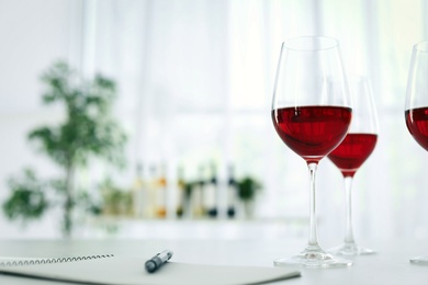 Glasses with delicious wine on table indoors