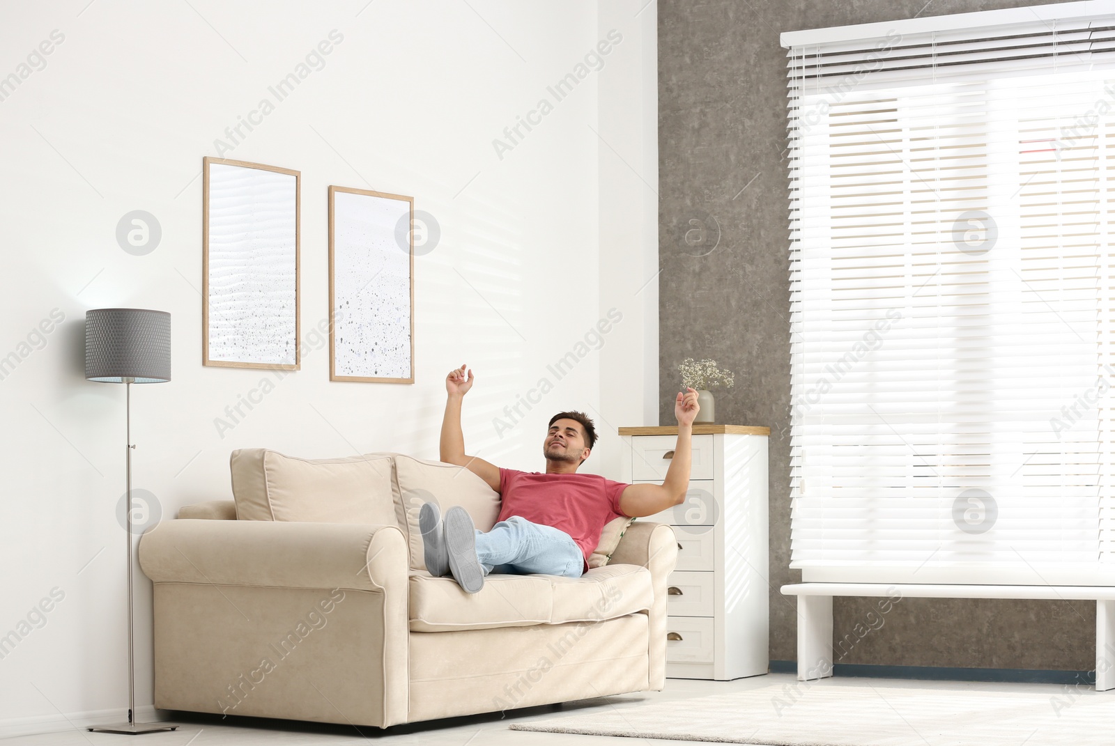 Photo of Young man relaxing on sofa at home