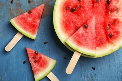 Photo of Flat lay composition with watermelon popsicles on wooden background