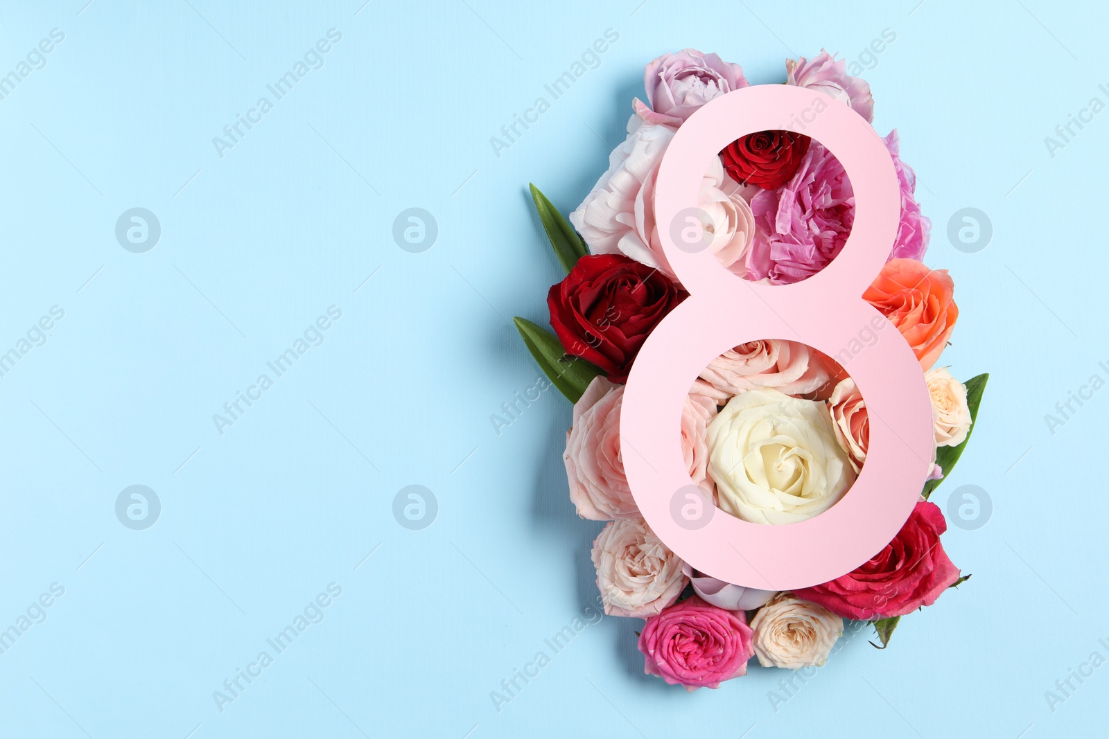 Photo of 8 March greeting card design with beautiful roses on light blue background, top view. Space for text