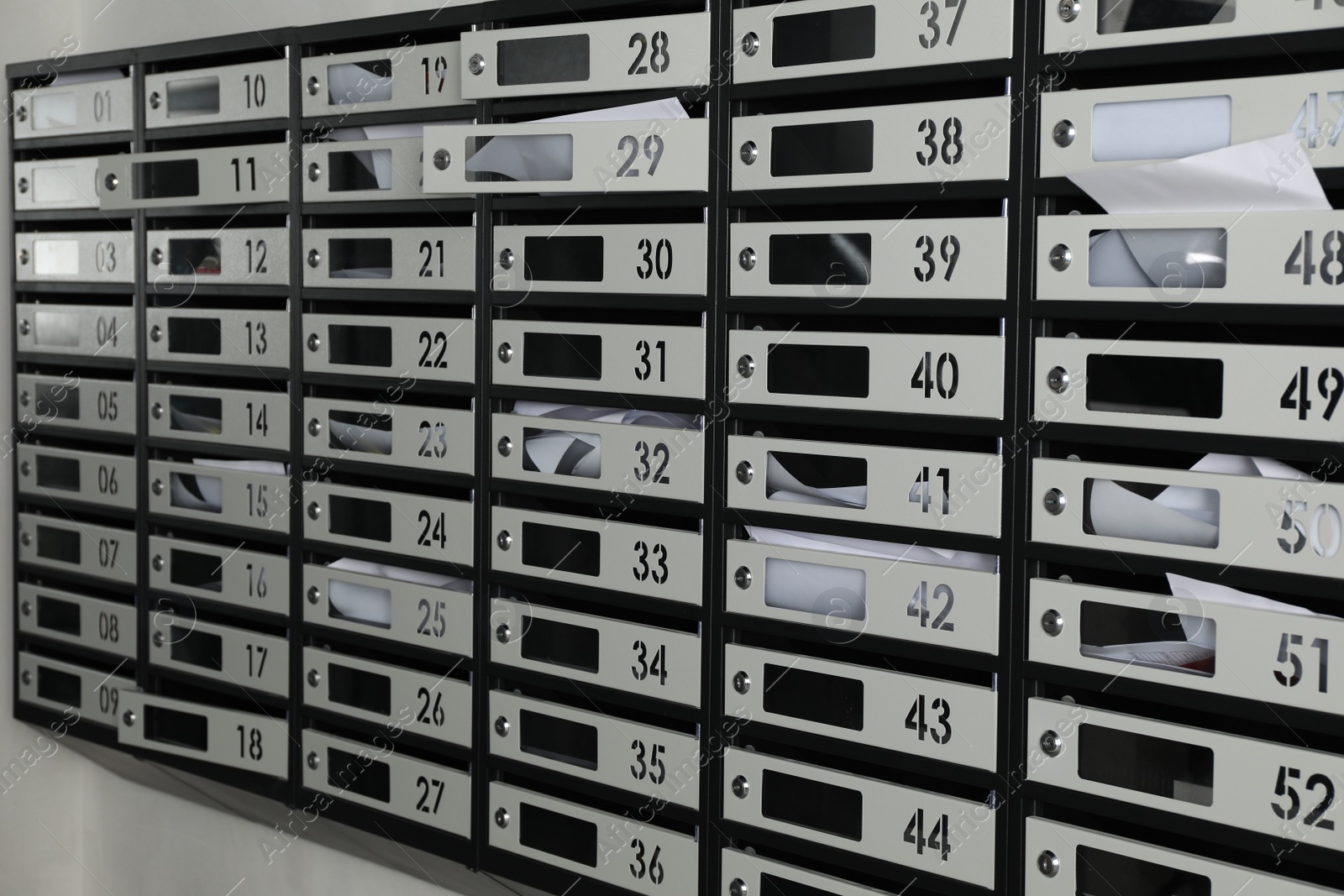 Photo of Metal mailboxes with keyholes, numbers and receipts in post office