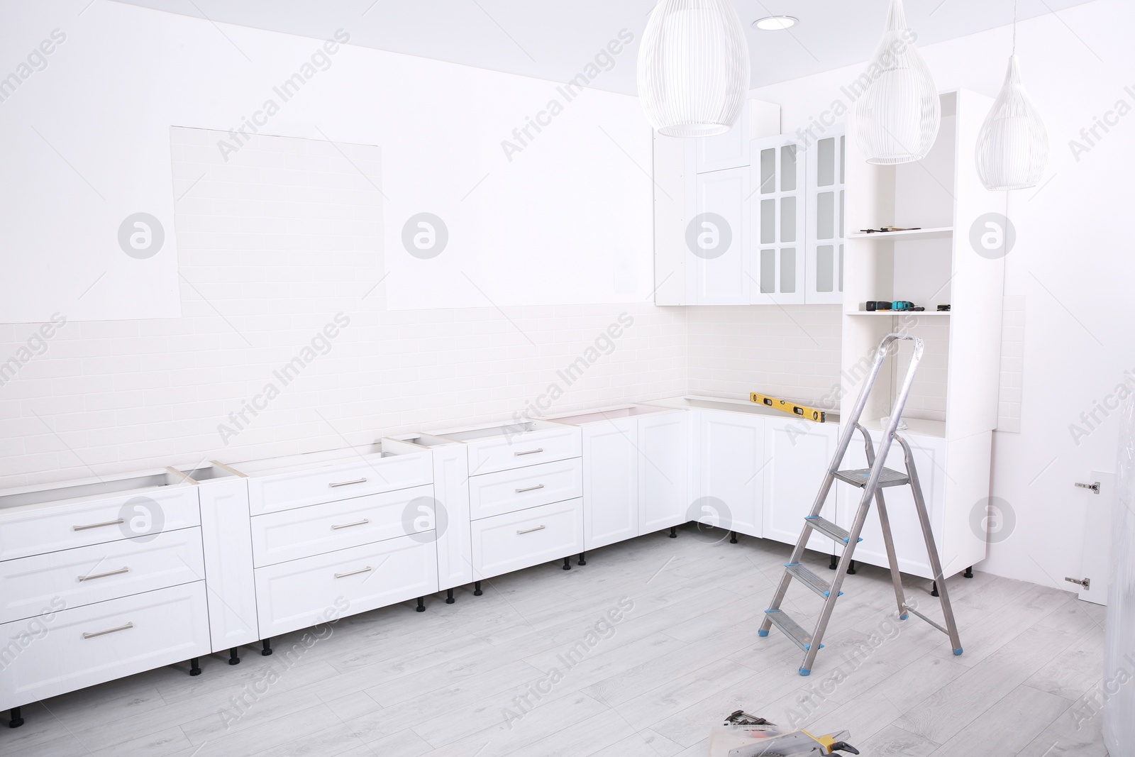 Photo of Stylish kitchen interior with newly installed furniture