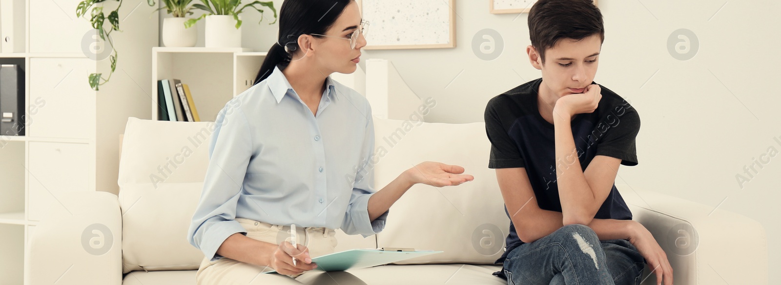 Image of Young psychologist working with teenage boy in office. Banner design