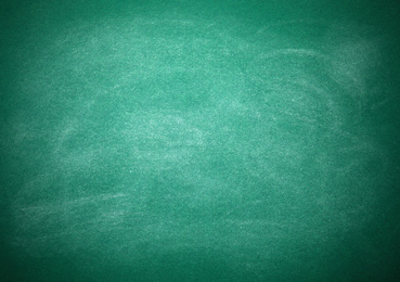 Photo of Chalk rubbed out on green board as background. Space for text