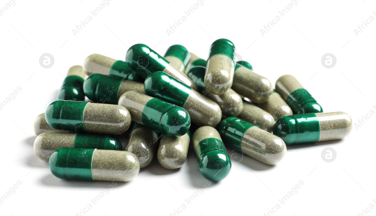 Photo of Heap of green spirulina capsules on white background. Alternative medicine