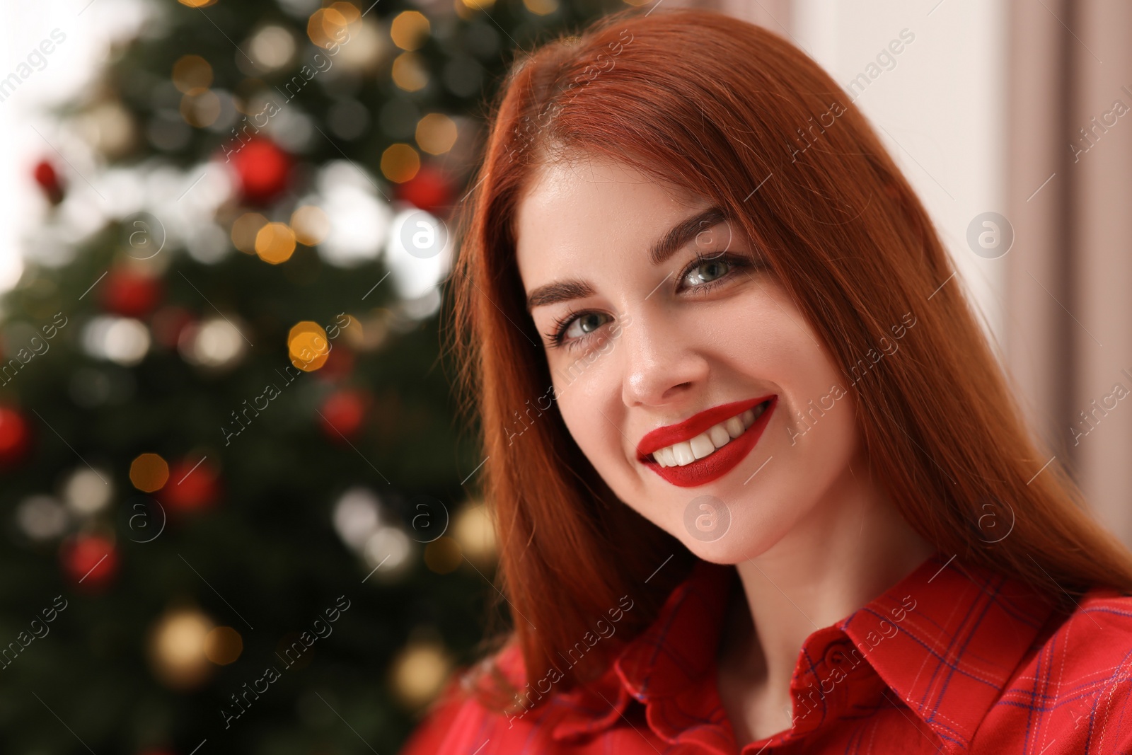 Photo of Beautiful young woman against blurred lights, closeup and space for text. Celebrating Christmas
