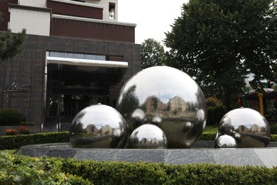 Photo of Truskavets, Ukraine - July 22, 2023: Beautiful fountain near hotel on city street