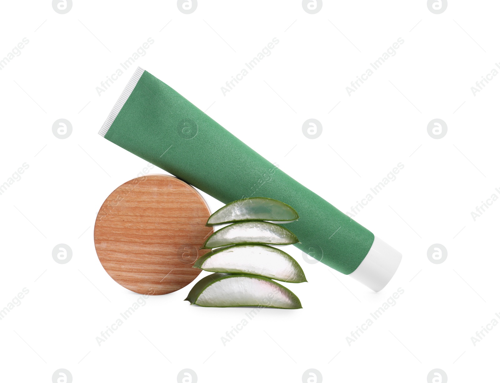 Photo of Tube of toothpaste, cut aloe vera and wooden decor on white background