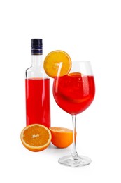 Photo of Bottle and glass of tasty Aperol spritz cocktail isolated on white