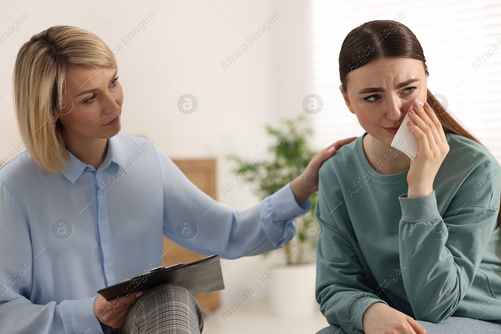 Photo of Professional psychotherapist working with patient in office