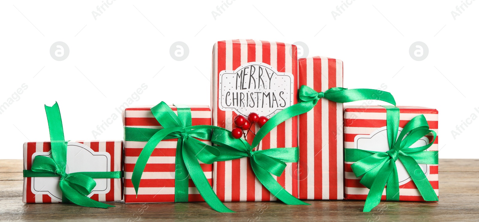 Photo of Many Christmas gifts on wooden table against white background