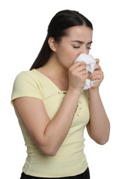 Photo of Sick young woman sneezing in tissue on white background. Cold symptoms