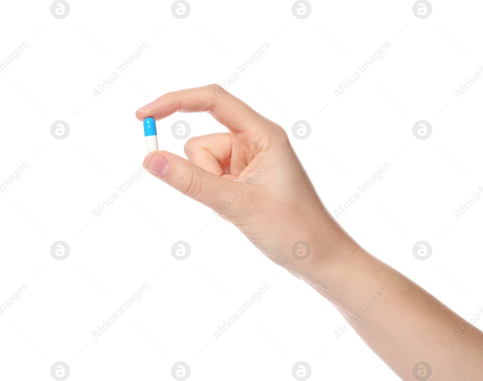 Photo of Woman holding color pill on white background, closeup