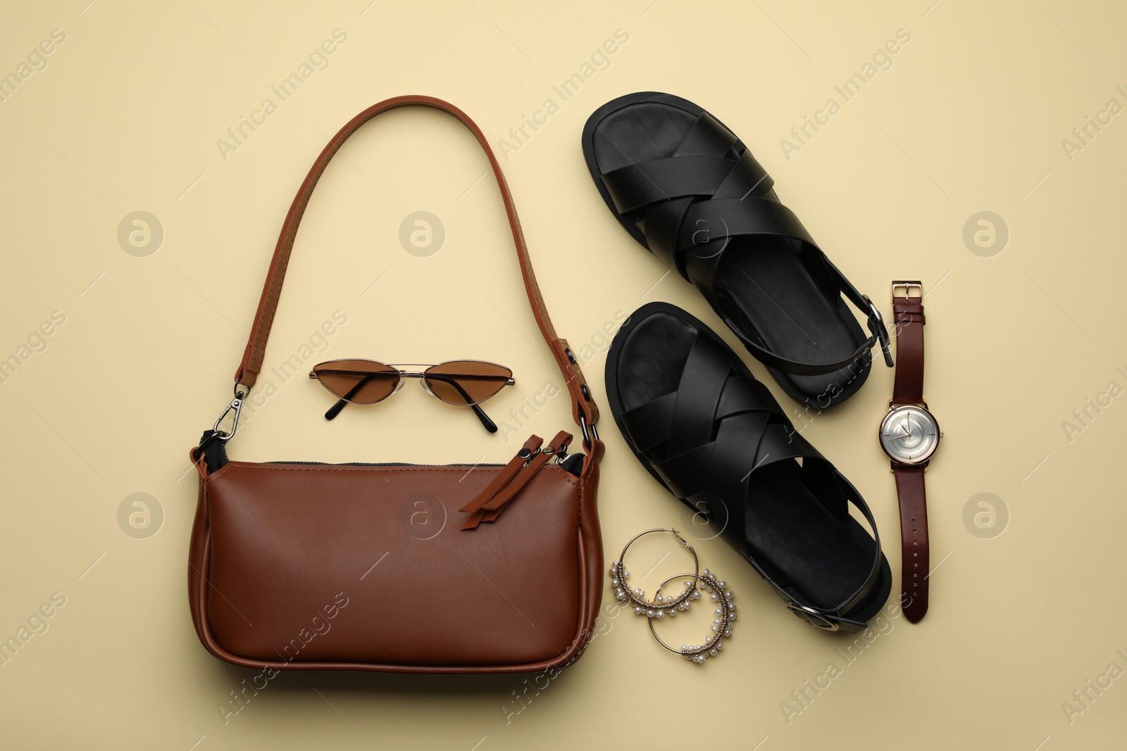 Photo of Stylish woman's bag, shoes and accessories on beige background, flat lay