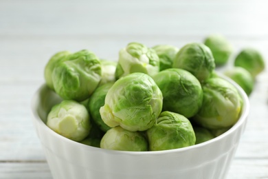 Bowl of fresh Brussels sprouts on table, closeup