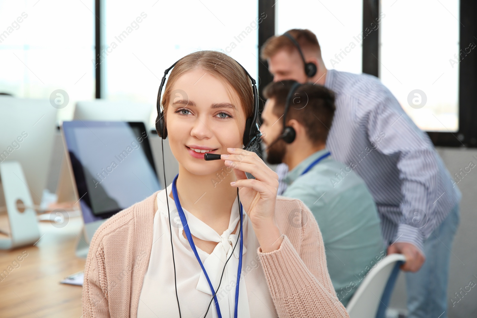 Photo of Technical support operator with colleagues in office