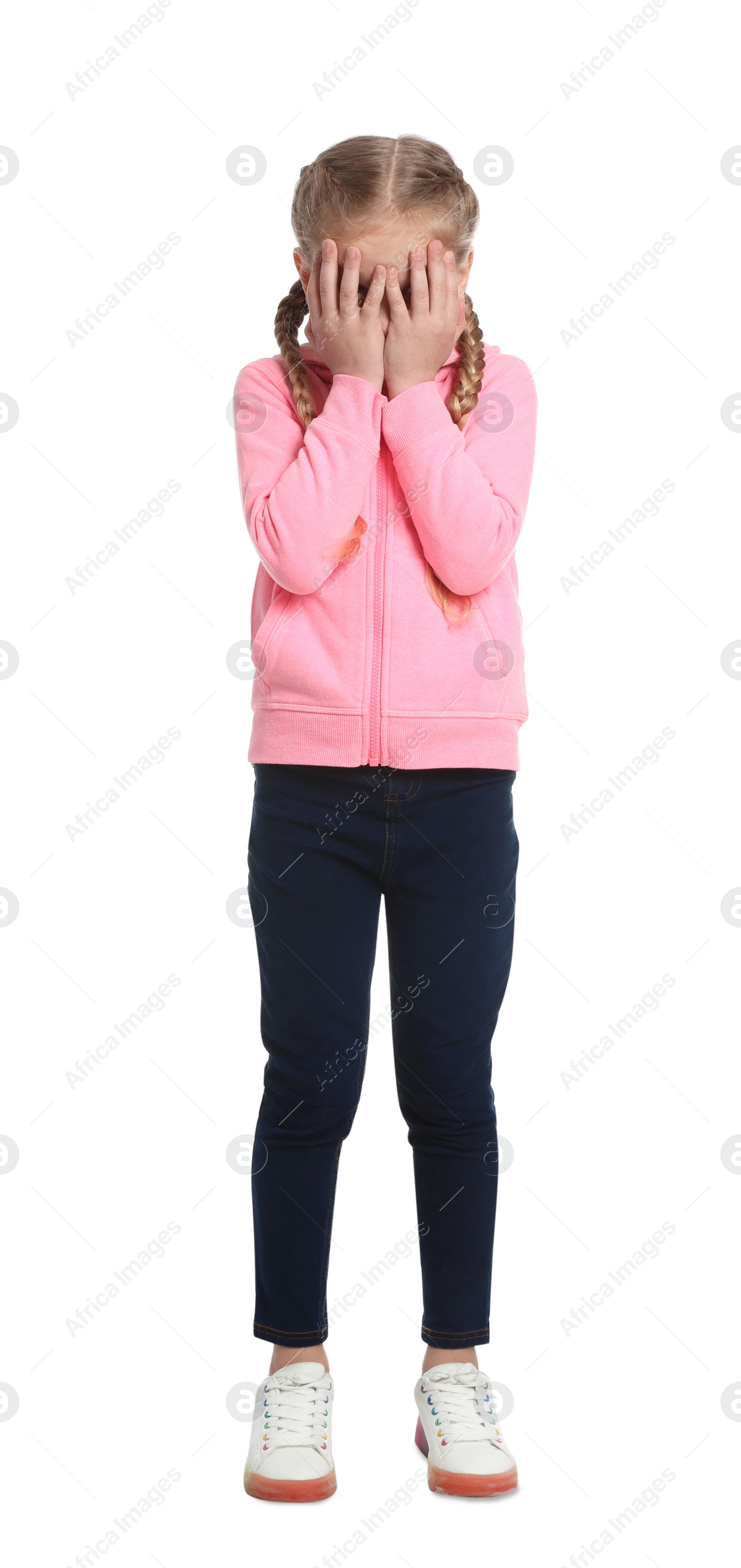 Photo of Girl covering face with hands on white background. Children's bullying