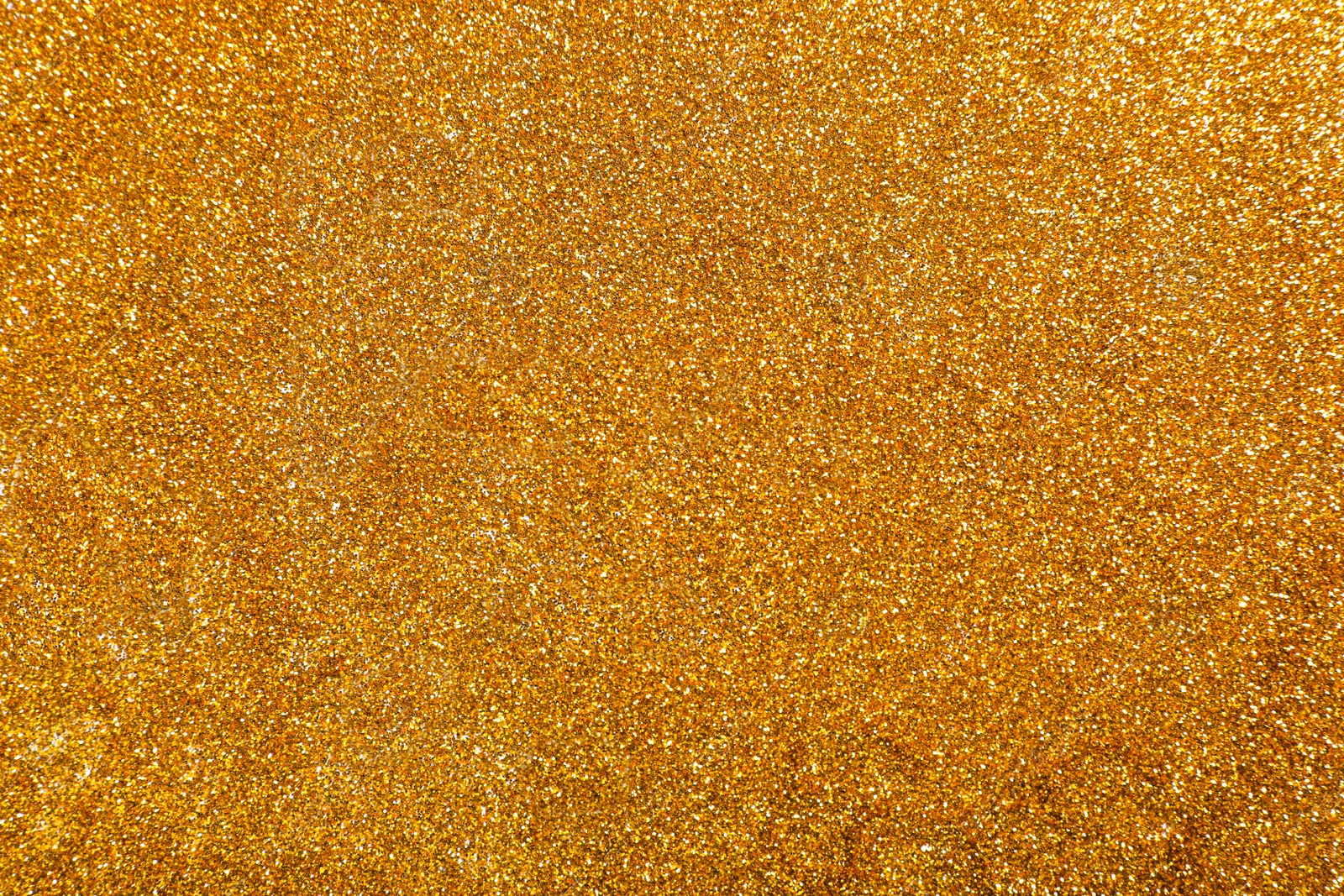 Photo of Shiny bright golden glitter as background, top view