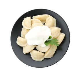 Photo of Delicious cooked dumplings with sour cream on white background, top view