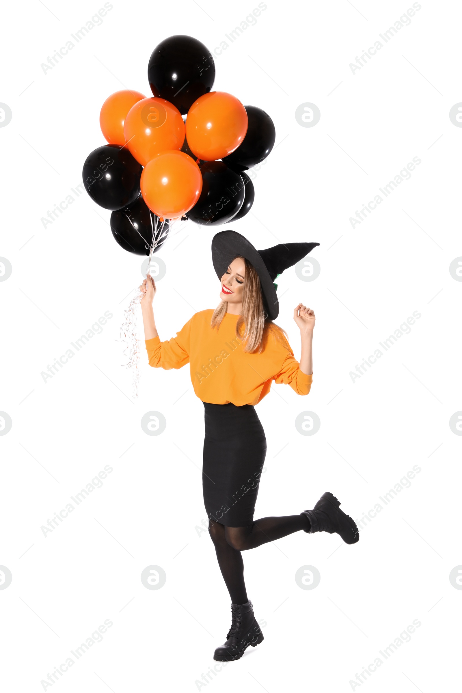 Photo of Beautiful woman wearing witch costume with balloons for Halloween party on white background