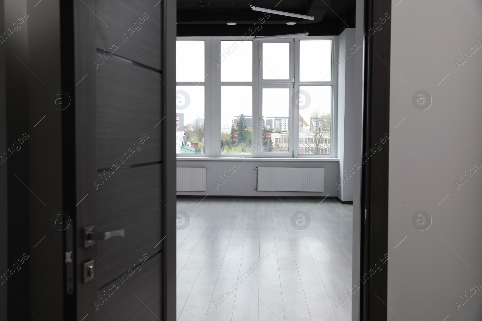 Photo of Modern empty office, view through open door