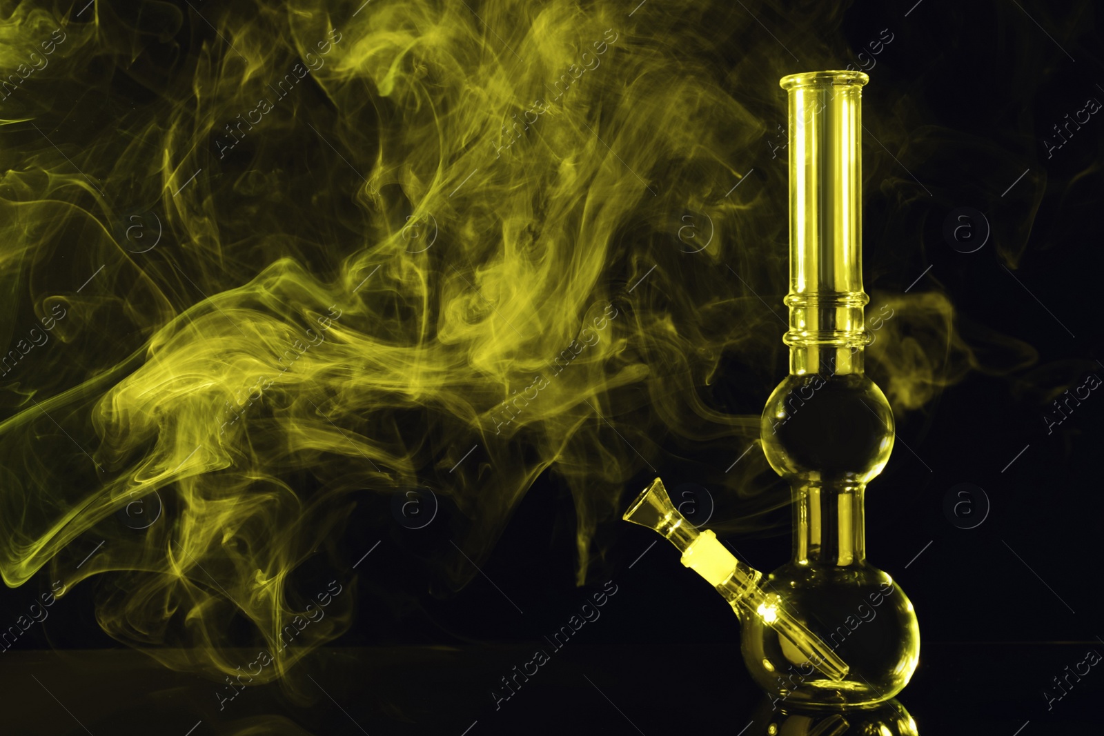 Photo of Glass bong and smoke on black background, space for text. Smoking device