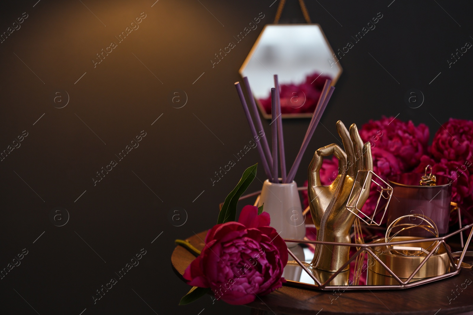 Photo of Composition with stylish accessories, flowers and interior elements on table indoors